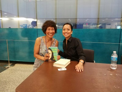 Mia Alvar, me, and a signed copy of her book.