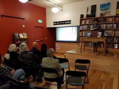 Reading at the stage of Third Place Books (photo courtesy of Peter Vershoor).